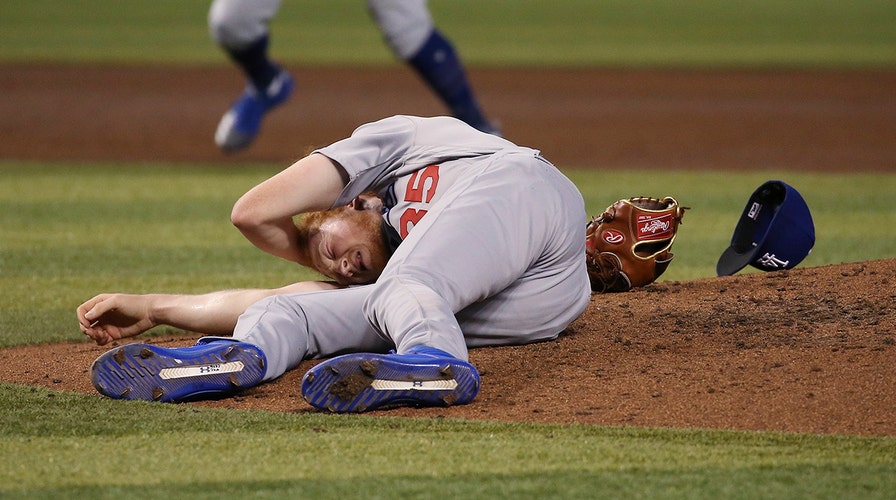 Los Angeles Dodgers' Dustin May takes liner off head during game