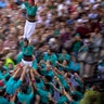 Participants walk maintaining a human tower or "Castellers" during the Saint Merce celebrations in San Jaume square in Barcelona, Spain, Sept. 24, 2019.
