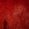 A woman looks at Chiharu Shiota's art installation titled "Uncertain Journey" at the Mori Art Museum, in Tokyo, Sept. 19, 2019.