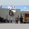 Police and fire personnel look on as workers remove a single-engine plane after it crashed into the terminal building shortly after takeoff at the Ak-Chin Regional Airport?in Maricopa, Arizona, Sept. 10, 2019.