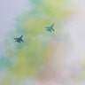 Chinese military planes fly in formation over a trail of colored smoke in Beijing, Sept. 22, 2019. 
