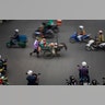 A mobile street vendor pushes a food cart while crossing a busy intersection in Bangkok, Thailand, Sept. 4, 2019. 