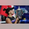 Bianca Andreescu, of Canada, kisses the championship trophy after defeating Serena Williams in the women's singles final at the U.S. Open tennis championships in New York, Sept. 7, 2019.
