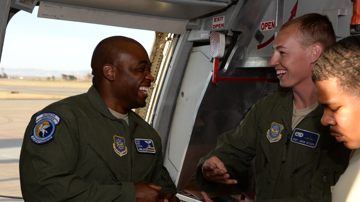 Tech. Sgt. Kenneth Cook (Left) shares a laugh with Staff Sgt. Jack McCoy. (U.S. Air Force photo by Tech. Sgt. James Hodgman)