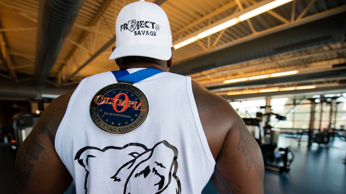 Tech. Sgt. Cook displays his medal from the United States Powerlifting Association's annual Olympia Pro Powerlifting Competition where he raw bench pressed 551 pounds. (U.S. Air Force photo by Senior Airman Jonathon Carnell)