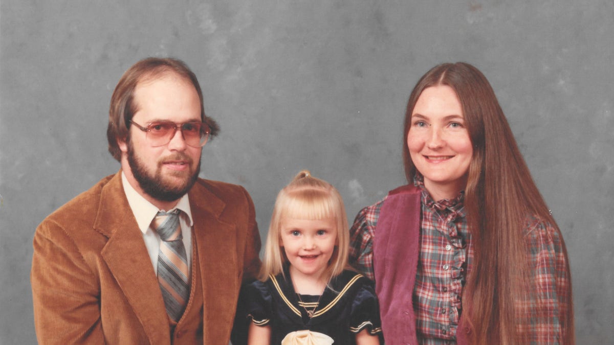 Maia with her parents, Cheryl and John Emmons.