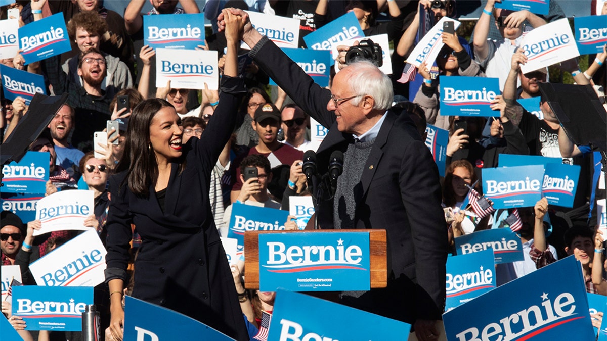 Democratic presidential candidate Sen. Bernie Sanders, I-Vt., right, is introduced by Rep. Alexandria Ocasio-Cortez, D-N.Y., during a campaign rally, Saturday, Oct. 19, 2019, in the Queens borough of New York. (AP Photo/Mary Altaffer)