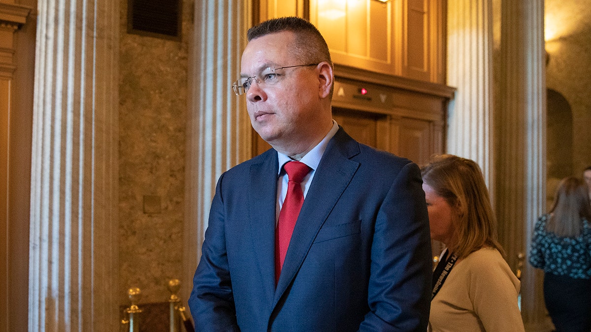 Pastor Andrew Brunson walks from the Senate chamber after giving the Senate opening prayer on Capitol Hill in Washington, Tuesday, Oct. 15, 2019. Brunson flew out of Turkey one year ago after a Turkish court convicted him of terror links but freed him from house arrest he'd already spent nearly two years in detention. (AP Photo/Manuel Balce Ceneta)