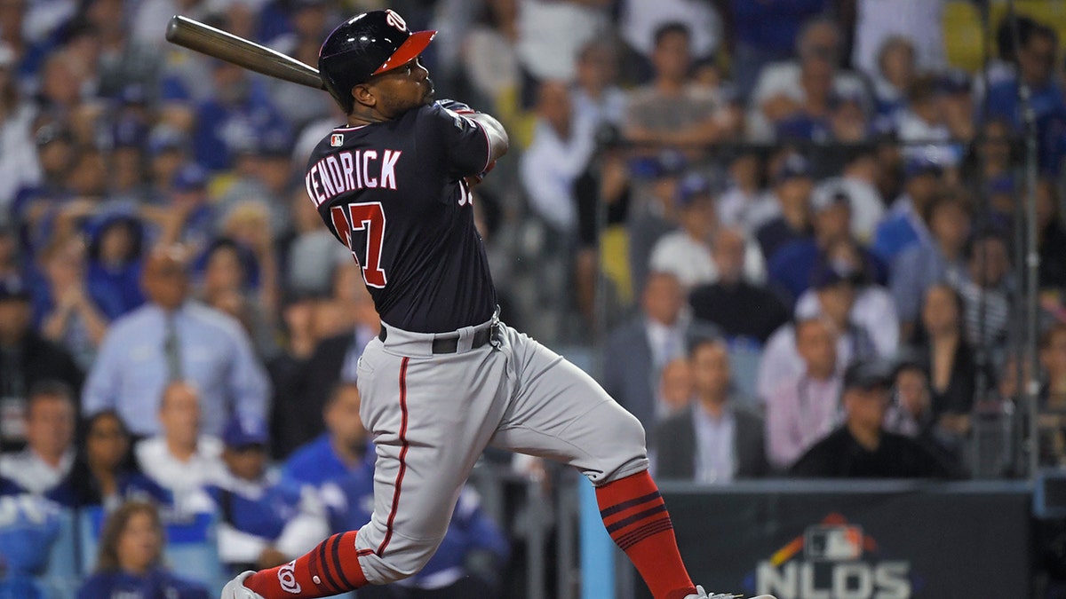 Washington Nationals' Howie Kendrick watches his grand slam against the Los Angeles Dodgers during the 10th inning in Game 5 of a baseball National League Division Series on Wednesday, Oct. 9, 2019, in Los Angeles. (Associated Press)