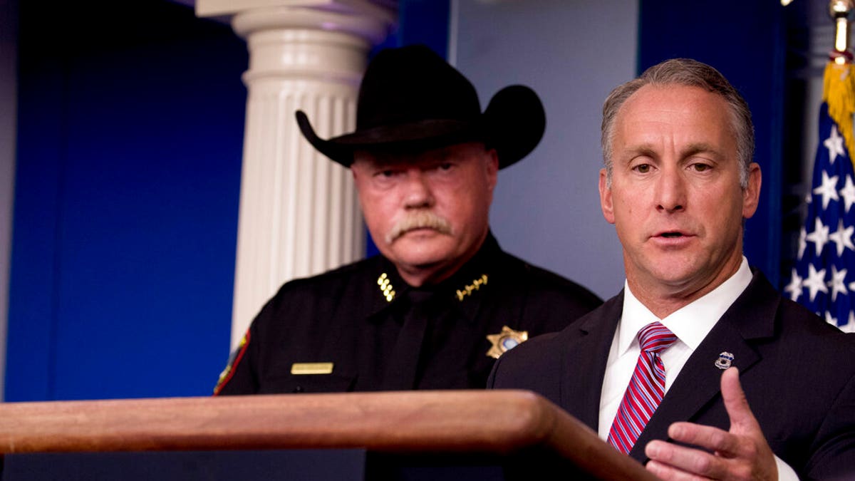 Immigration and Customs Enforcement Director Matt Albence, right, accompanied by sheriffs from around the country including Tarrant County, Texas Sheriff Bill Waybourn, left, speaks in the Briefing Room at the White House in Washington, Thursday, Oct. 10, 2019. (AP Photo/Andrew Harnik)