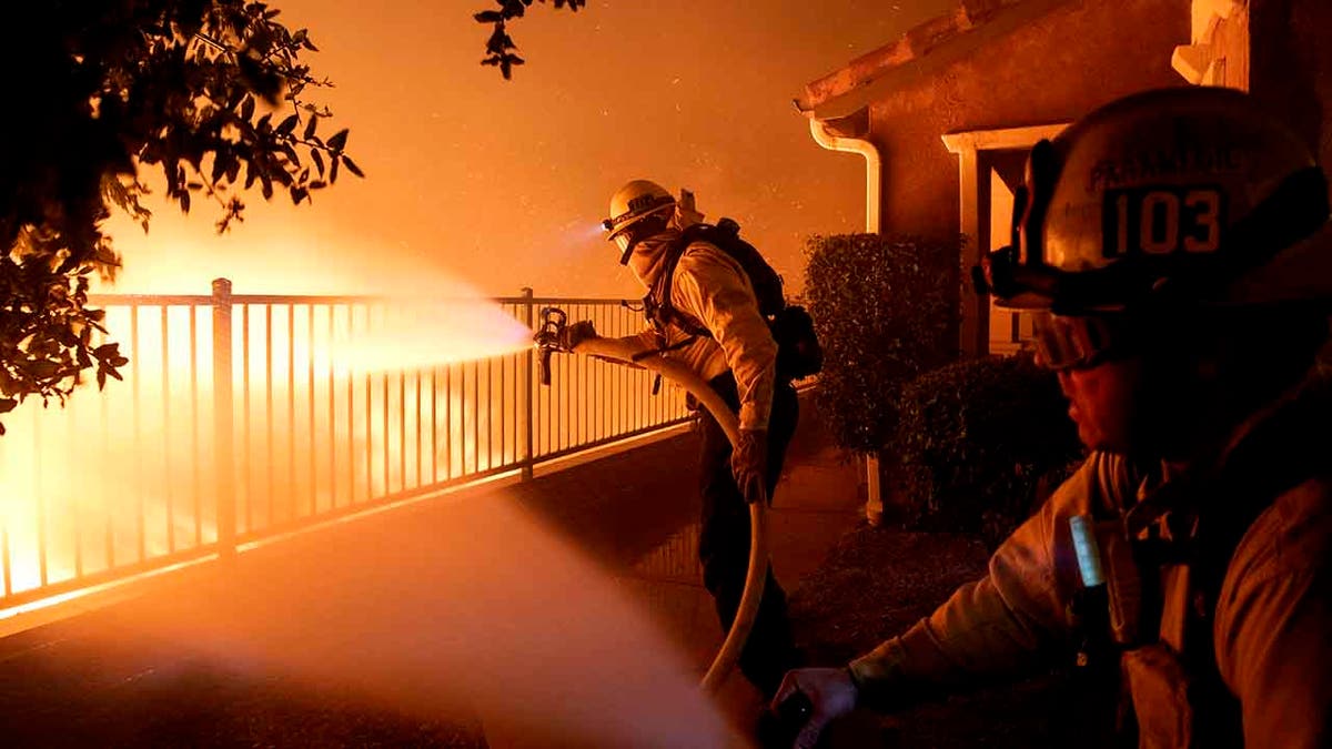 In this Thursday, Oct. 10, 2019 photo, Los Angeles City firefighters battle the Saddleridge fire near homes in Sylmar, Calif. (Associated Press)