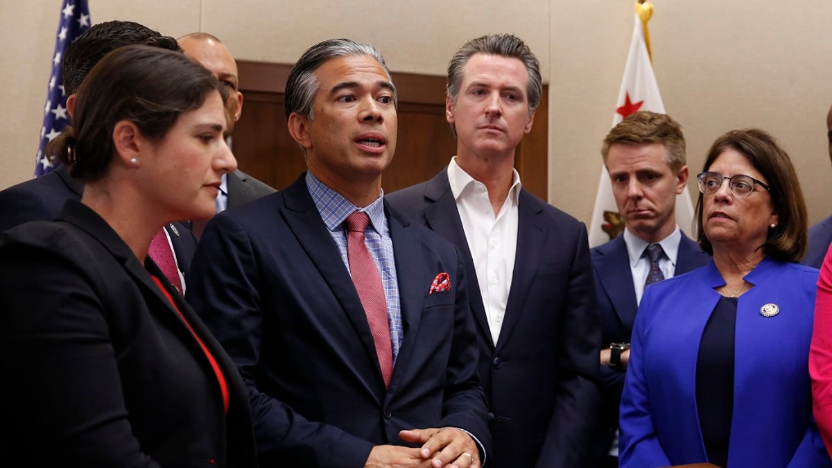 Assemblyman Rob Bonta, D-Oakland, second from left, flanked by California Gov. Gavin Newsom, center, and other lawmakers, discusses his measure on for-profit detention facilities on Friday in Sacramento. (AP Photo/Rich Pedroncelli)