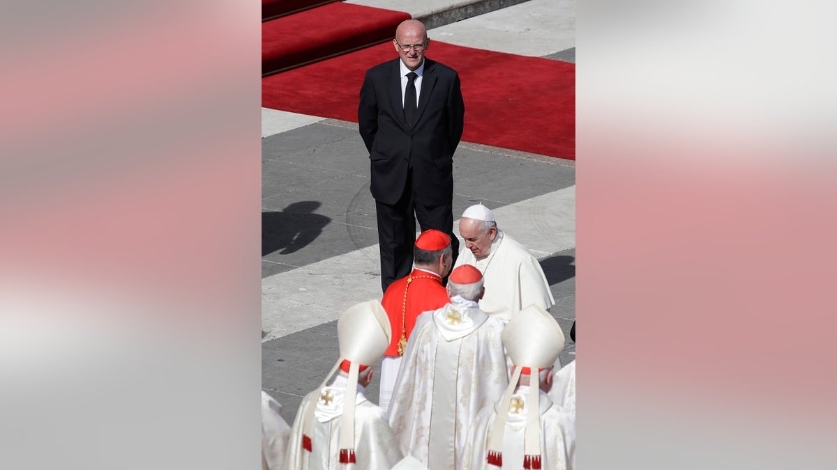 Vatican head of security Domenico Giani, top, looks at Pope Francis at the end of a canonization Mass in St. Peter's Square at the Vatican on Sunday. (AP Photo/Alessandra Tarantino)