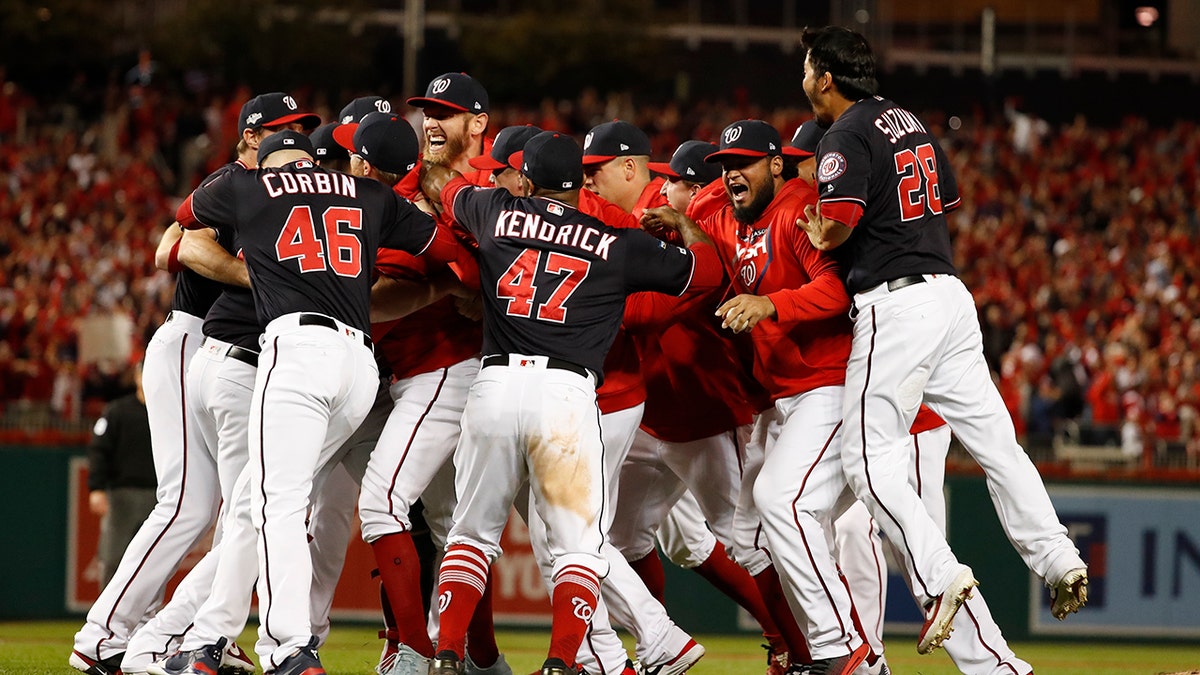 The Washington Nationals celebrate after Game 4 of the baseball National League Championship Series Tuesday, Oct. 15, 2019, in Washington. The Nationals won 7-4 to win the series 4-0. (AP Photo/Jeff Roberson)