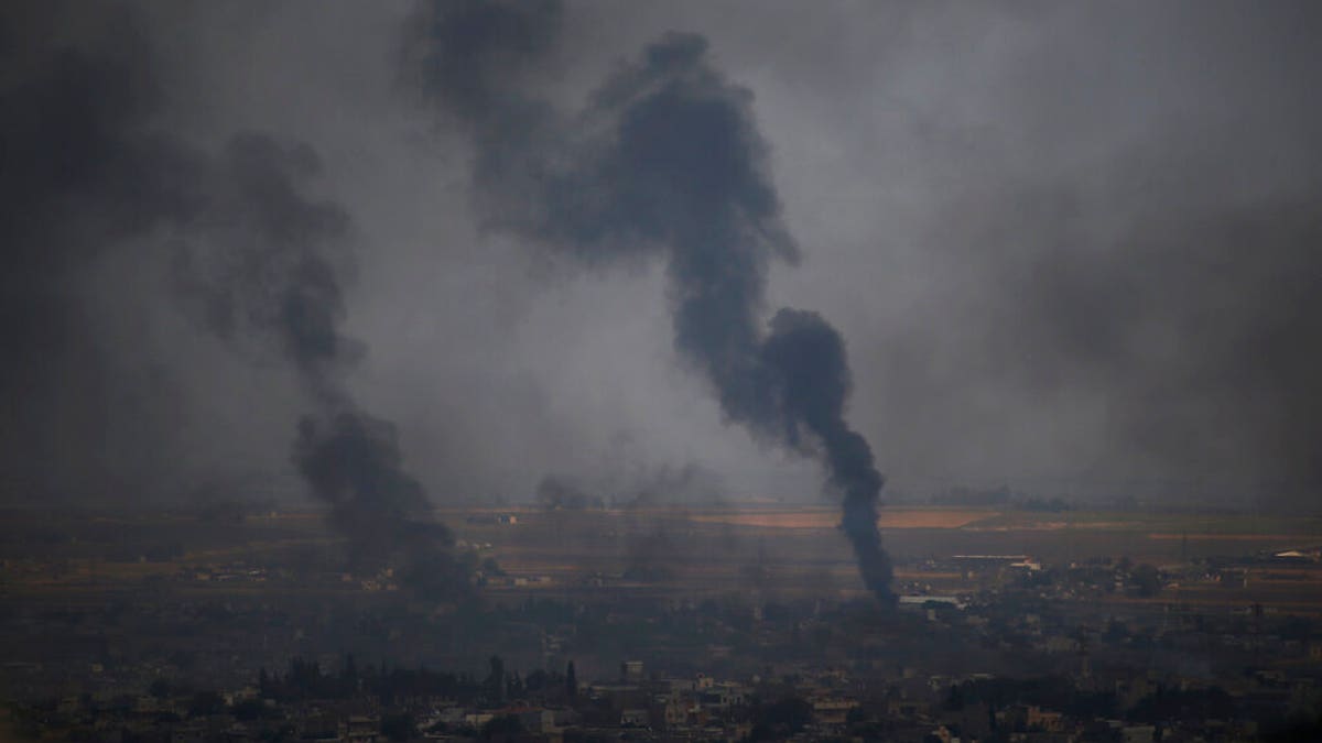 In this photo taken from the Turkish side of the border between Turkey and Syria, in Ceylanpinar, Sanliurfa province, southeastern Turkey, smoke billows from targets in Ras al-Ayn, Syria, during bombardment by Turkish forces, Wednesday, Oct. 16, 2019. Turkey's President Recep Tayyip Erdogan called Wednesday on Syrian Kurdish fighters to leave a designated border area in northeast Syria 'as of tonight' for Turkey to stop its military offensive, defying pressure on him to call a ceasefire and halt its incursion into Syria, now into its eighth day. (AP Photo/Lefteris Pitarakis)