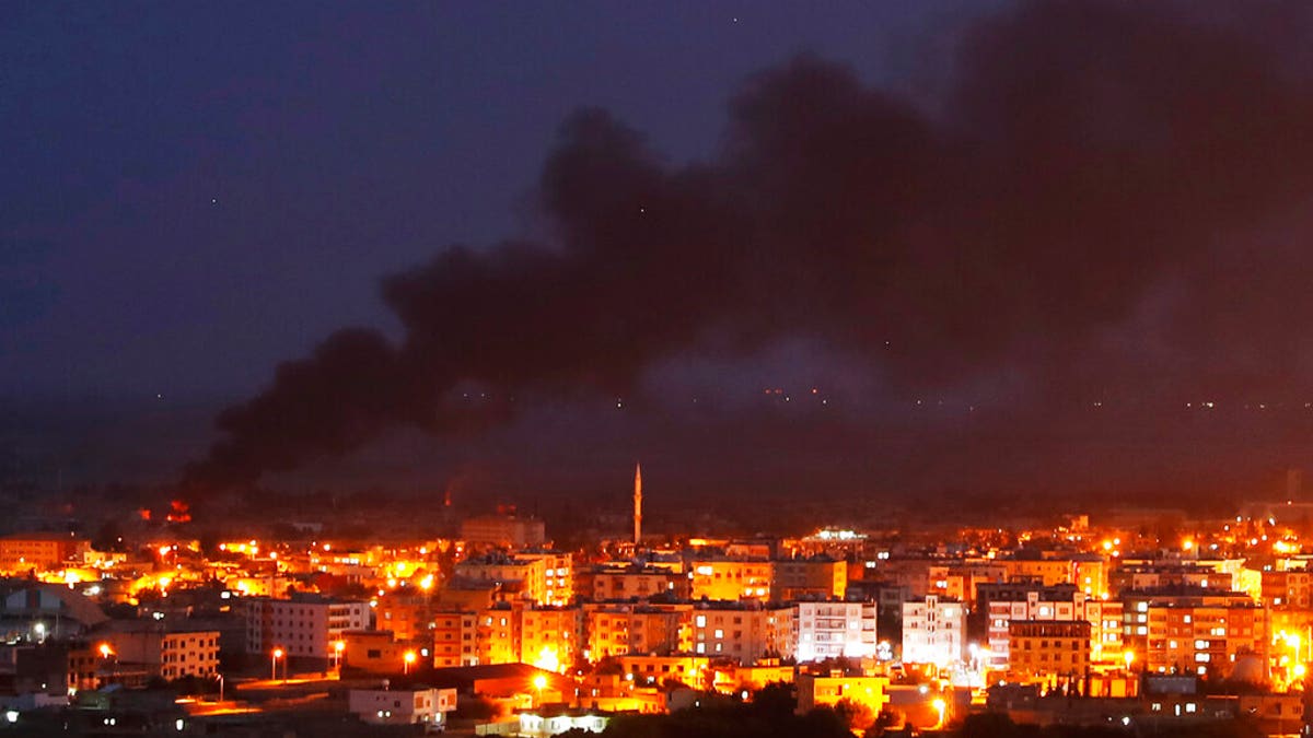 In this photo taken from the Turkish side of the border between Turkey and Syria, in Ceylanpinar, Sanliurfa province, southeastern Turkey, smoke billowed from fires in Ras al-Ayn, Syria, caused by bombardment by Turkish forces, on Wednesday. (AP Photo/Lefteris Pitarakis)