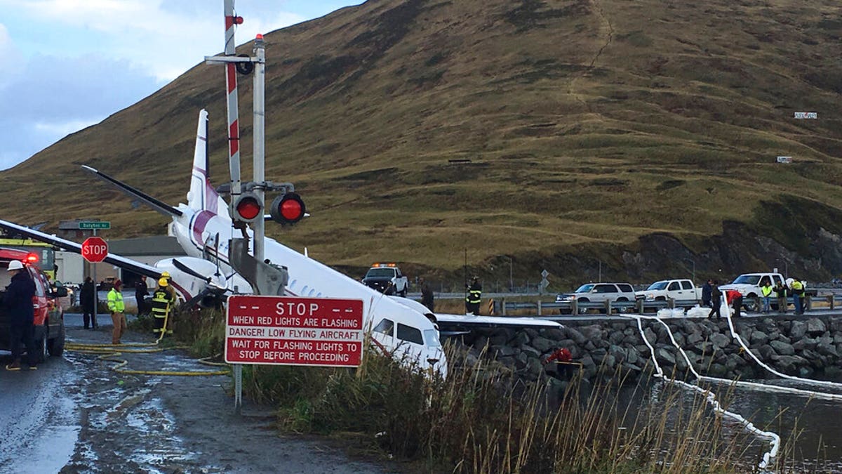 A commuter airplane has crashed near the airport in a small Alaska community on the Bering Sea, Thursday, Oct. 17, 2019, in Unalaska, Alaska. Freelance photographer Jim Paulin says the crash at the Unalaska airport occurred Thursday after 5 p.m. Paulin says the Peninsula Airways flight from Anchorage to Dutch Harbor landed about 500 feet beyond the airport near the water.