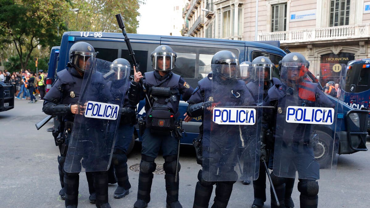 Riot police get ready in Barcelona, Spain, Saturday, Oct. 19, 2019. Barcelona and the rest of the restive Spanish region of Catalonia are reeling from five straight days of violent protests for the sentencing of 12 separatist leaders to lengthy prison sentences.The riots have broken out at nightfall following huge peaceful protests each day since Monday's Supreme Court verdict. (AP Photo/Manu Fernandez)