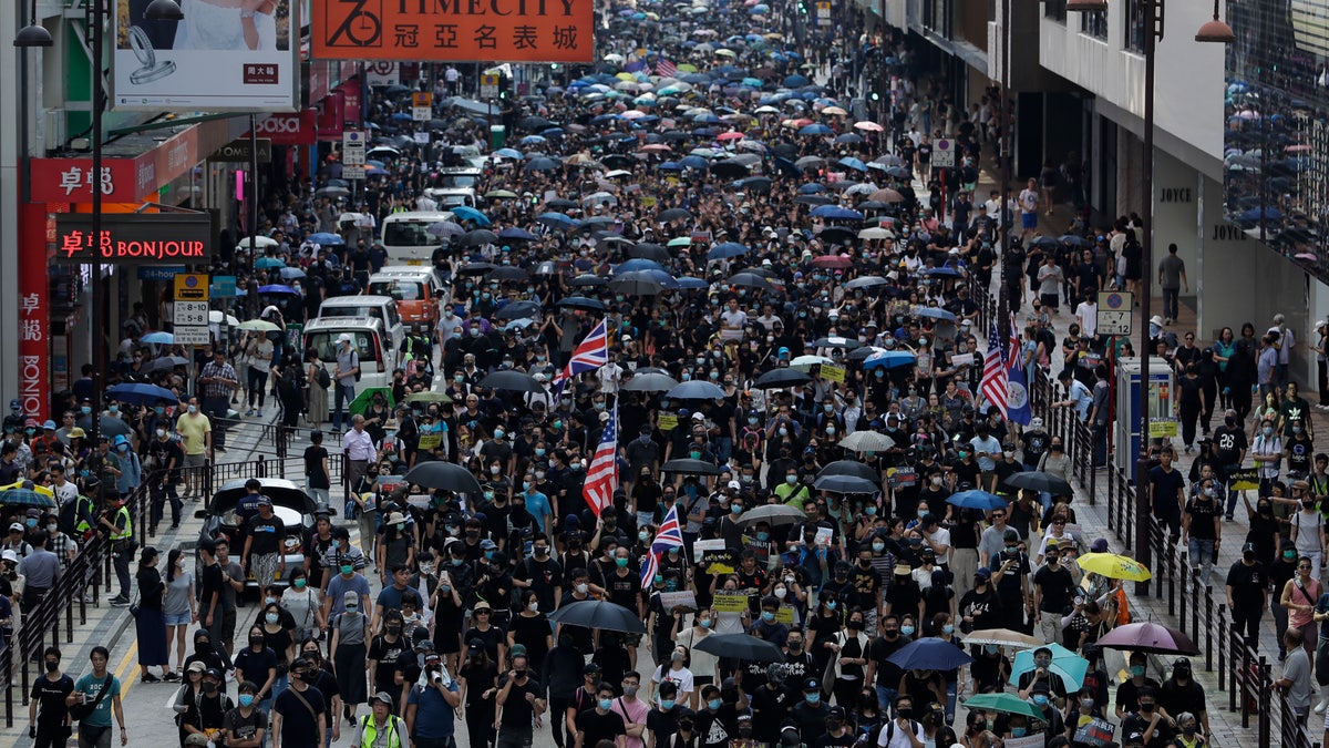 Thousands of protesters march during a rally in Hong Kong, Sunday, Oct. 20, 2019. Hong Kong protesters again flooded streets on Sunday, ignoring a police ban on the rally and demanding the government meet their demands for accountability and political rights. (AP Photo/Mark Schiefelbein)