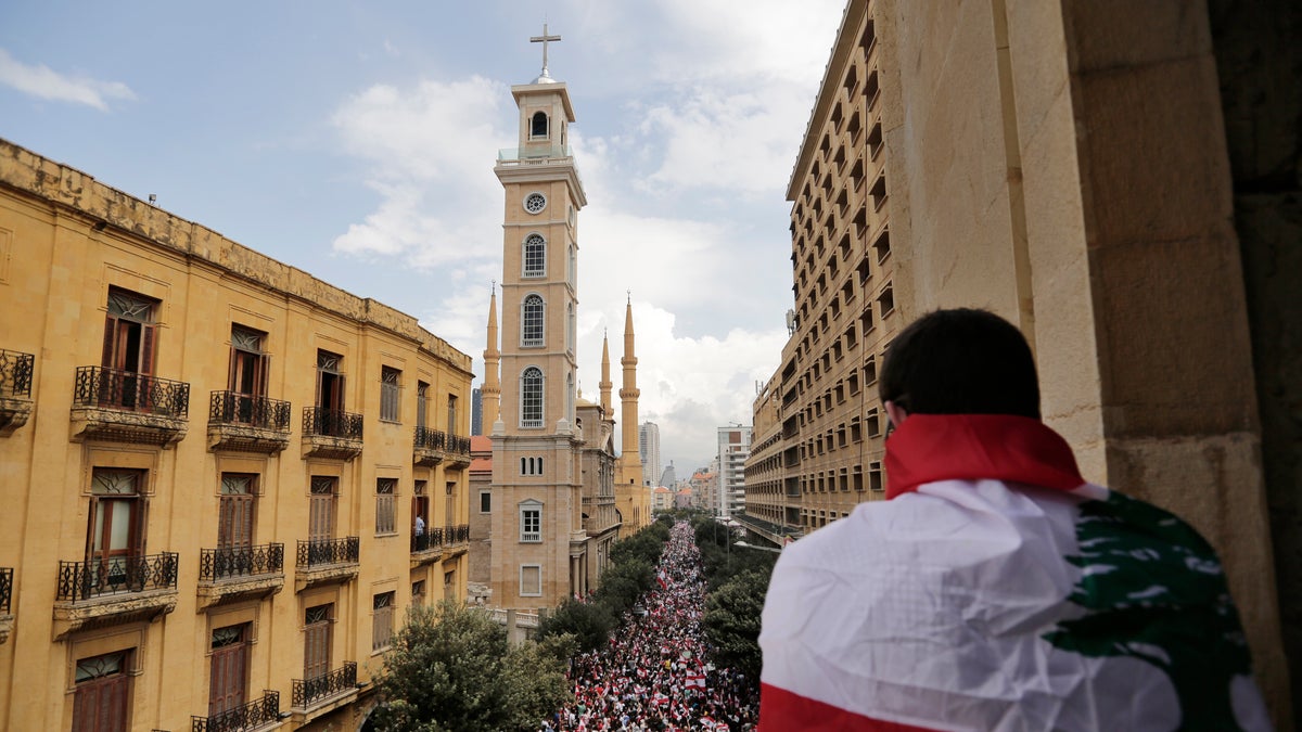 Anti-government protesters shout slogans in Beirut, Lebanon, Sunday, Oct. 20, 2019. Thousands of people are gathering in downtown Beirut as Lebanon is expected to witness the largest protests on the fourth day of anti-government demonstrations. (AP Photo/Hassan Ammar)