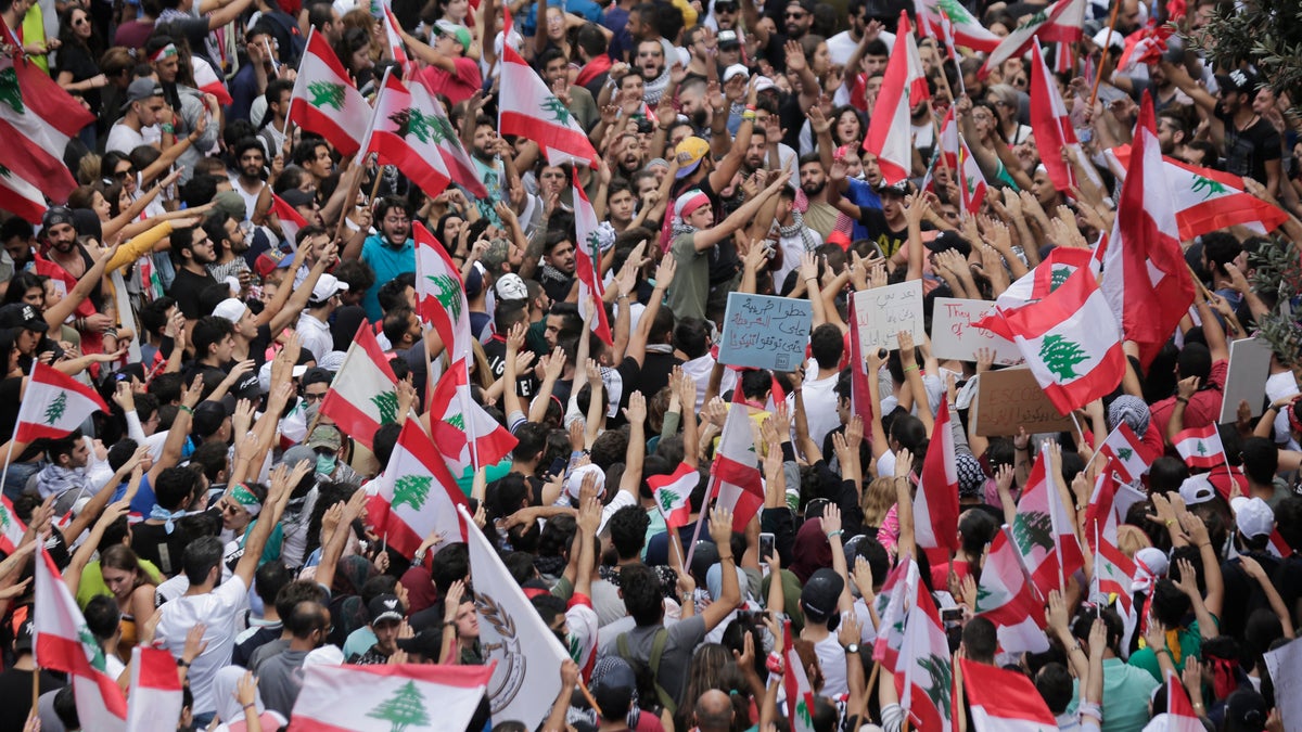 Anti-government protesters shout slogans in Beirut, Lebanon, Sunday, Oct. 20, 2019. Thousands of people are gathering in downtown Beirut as Lebanon is expected to witness the largest protests on the fourth day of anti-government demonstrations. (AP Photo/Hassan Ammar)