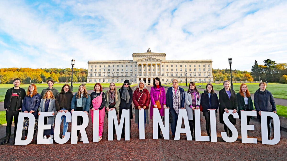 Pro-choice activists take part in a photo call in the grounds of Stormont Parliament, Belfast, Monday Oct. 21, 2019. Abortion is set to be decriminalized and same-sex marriage legalized in Northern Ireland as of midnight, bringing its laws in line with the rest of the U.K. (Niall Carson/PA via AP)