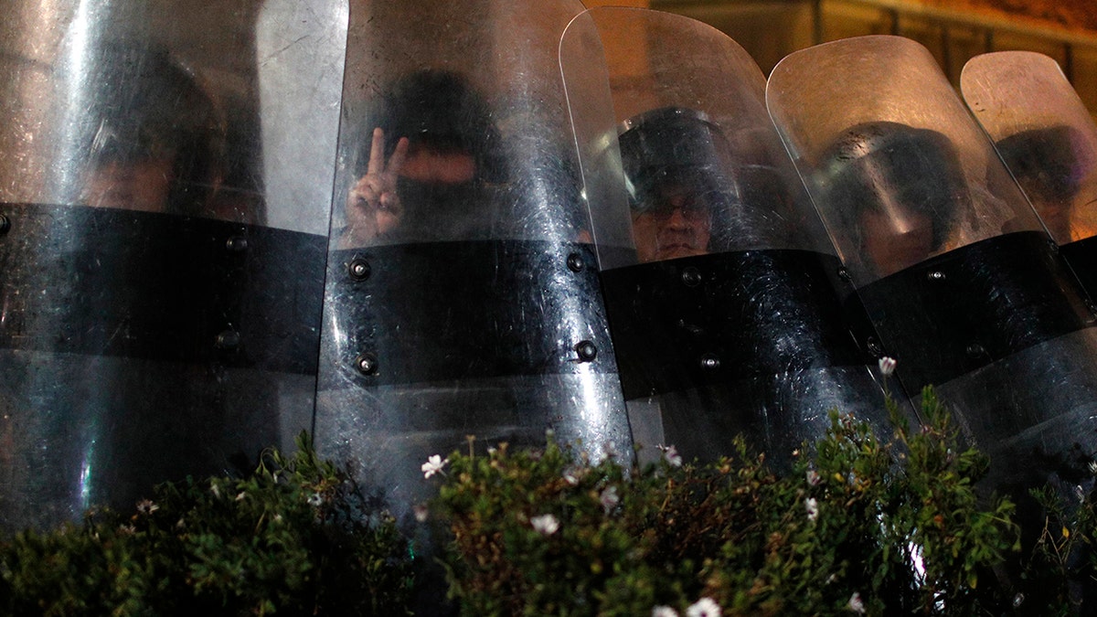 Police block protesters from entering the Supreme Electoral Court where election ballots are being counted in La Paz, Bolivia.