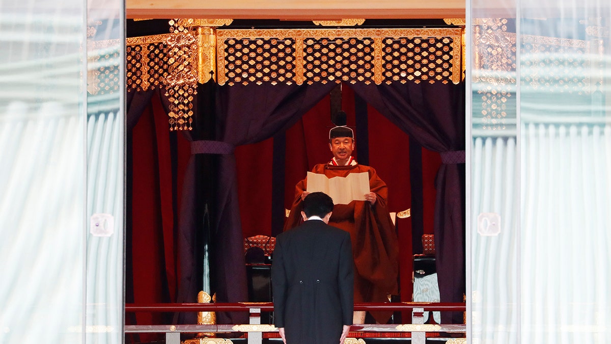 Japanese Prime Minister Shinzo Abe bows to Emperor Naruhito