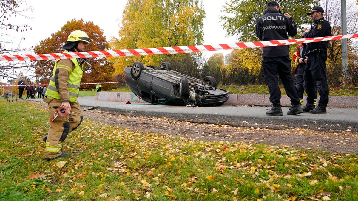 An upturned car is cordoned off by police after an incident in the center of Oslo, Tuesday, Oct. 22, 2019. 