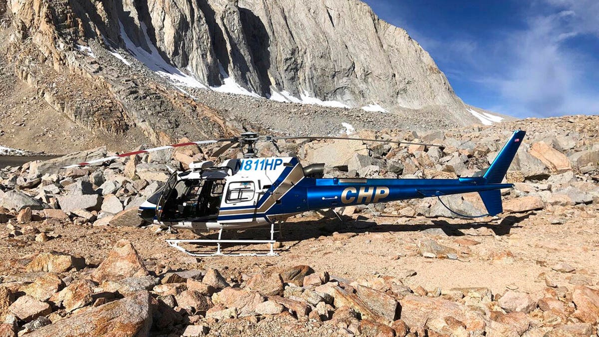 In this Oct. 16 photo released by the California Highway Patrol, their H-80 helicopter sits near where a human skeleton was discovered on Mount Williamson. 