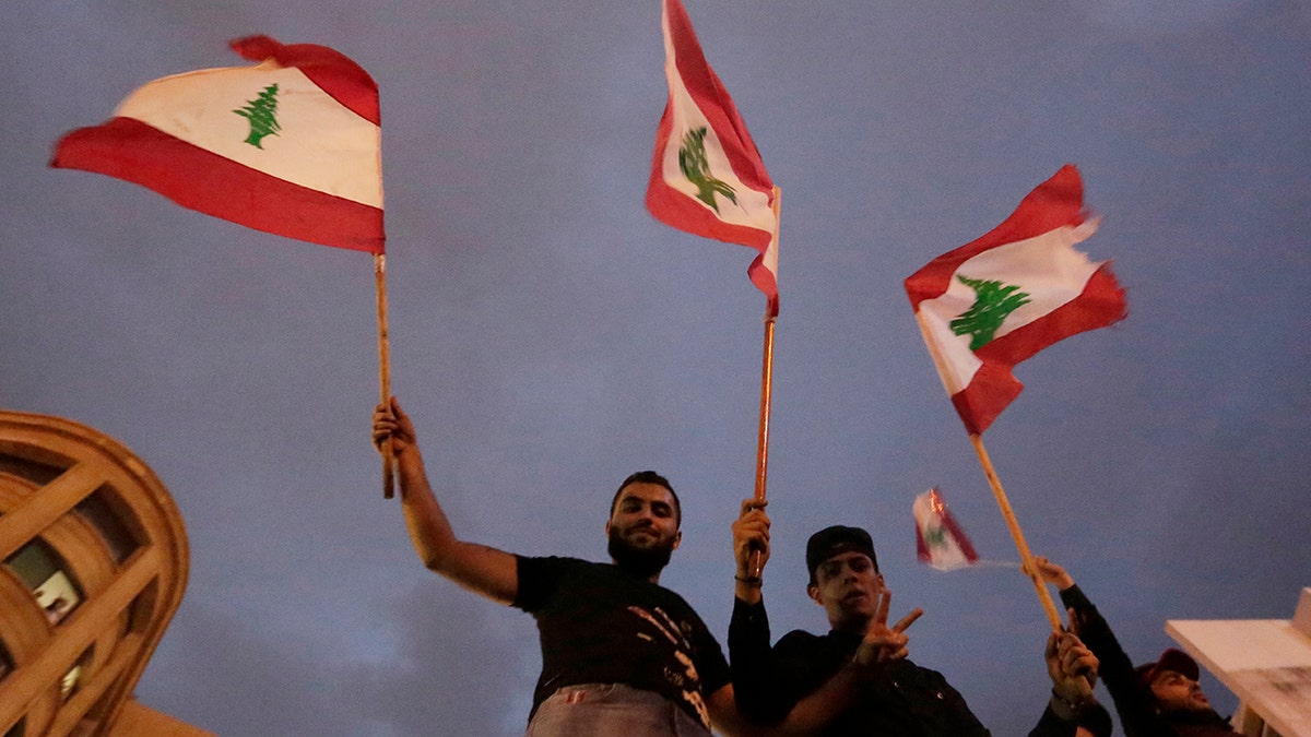 Lebanon's President Michel Aoun has told tens of thousands of protesters that an economic reform package put forth by the country's prime minister will be the "first step" toward saving Lebanon from economic collapse. (AP Photo/Hassan Ammar)