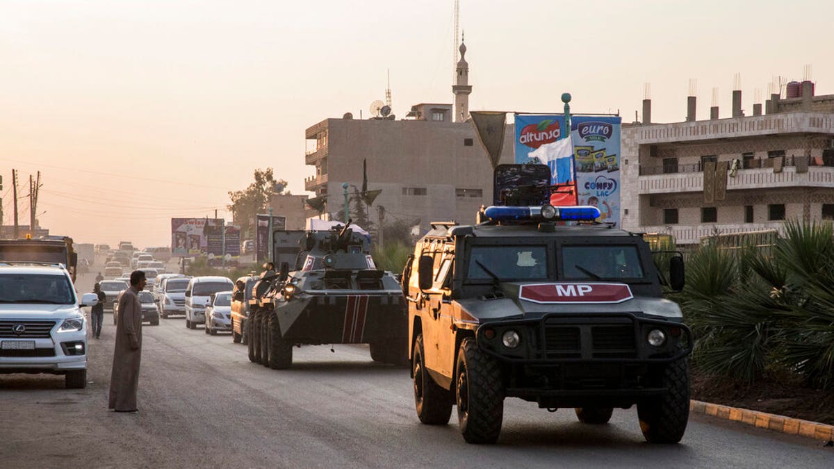 Russian forces patrol in the city of Amuda, north Syria, Thursday, Oct. 24, 2019. Syrian forces, Russian military advisers and military police are being deployed in a zone 30 kilometers (19 miles) deep along much of the northeastern border, under an agreement reached Tuesday by Russia and Turkey.