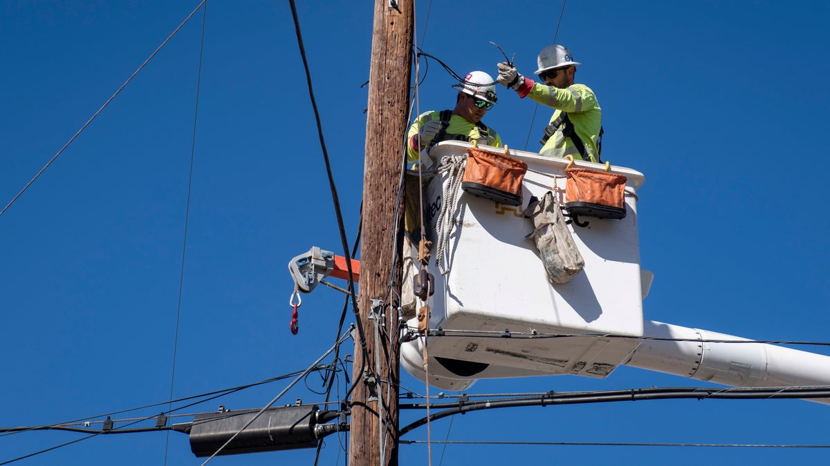 SoCal Edison crews replace power lines that were damaged from the Tick Fire, Thursday, Oct. 25, 2019, in Santa Clarita, Calif. An estimated 50,000 people were under evacuation orders in the Santa Clarita area north of Los Angeles as hot, dry Santa Ana winds howling at up to 50 mph (80 kph) drove the flames into neighborhoods (AP Photo/ Christian Monterrosa)from the Tick Fire, Thursday, Oct. 25, 2019, in Santa Clarita, Calif. An estimated 50,000 people were under evacuation orders in the Santa Clarita area north of Los Angeles as hot, dry Santa Ana winds howling at up to 50 mph (80 kph) drove the flames into neighborhoods (AP Photo/ Christian Monterrosa)