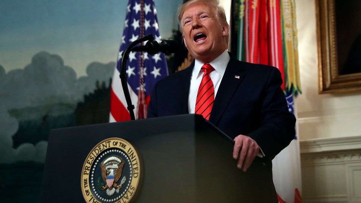 President Donald Trump speaks in the Diplomatic Room of the White House Sunday. (AP Photo/Andrew Harnik)