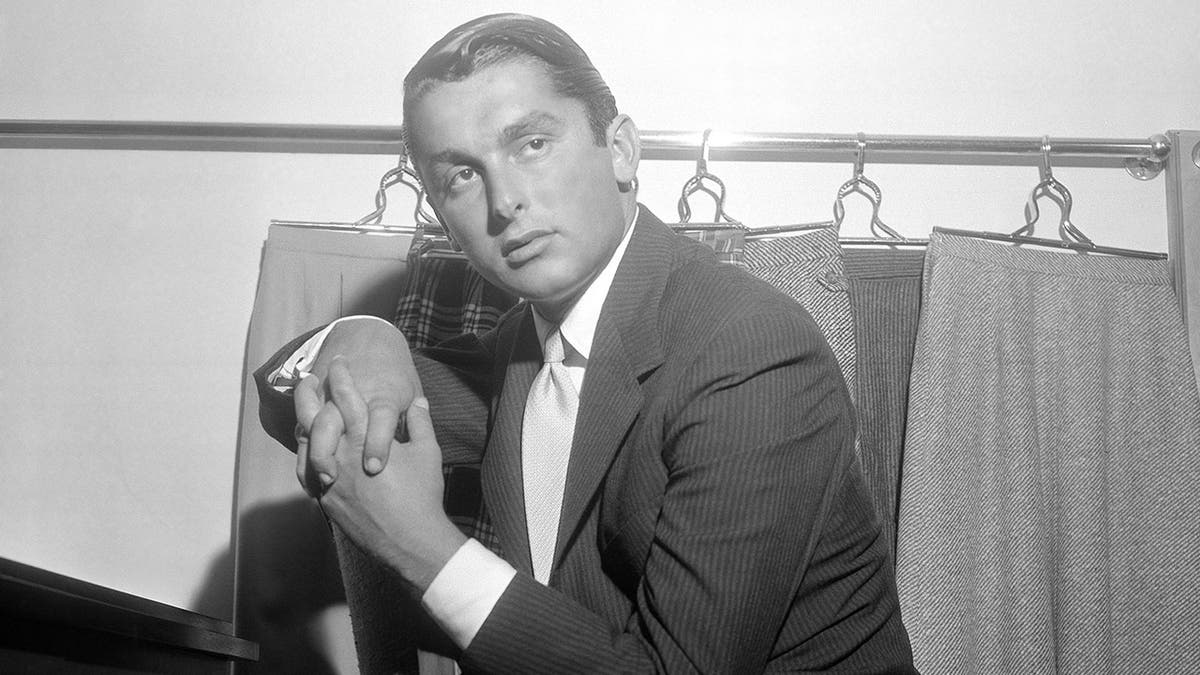 This July 31, 1957 File photo shows actor and sportswear executive Robert Evans, shown in his office in New York.