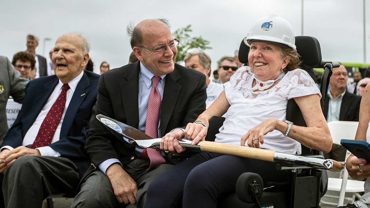 Former U.S. Sen. Kay Hagan, right, smiles with her husband, Chip Hagan, as she wears a hard hat during the ground breaking for a new, 180-foot-tall air traffic control tower at Piedmont Triad International Airport in Greensboro, N.C., on Wednesday, June 5, 2019. Hagan, who served in the Senate from 2008 through 2014, died Monday at 66.