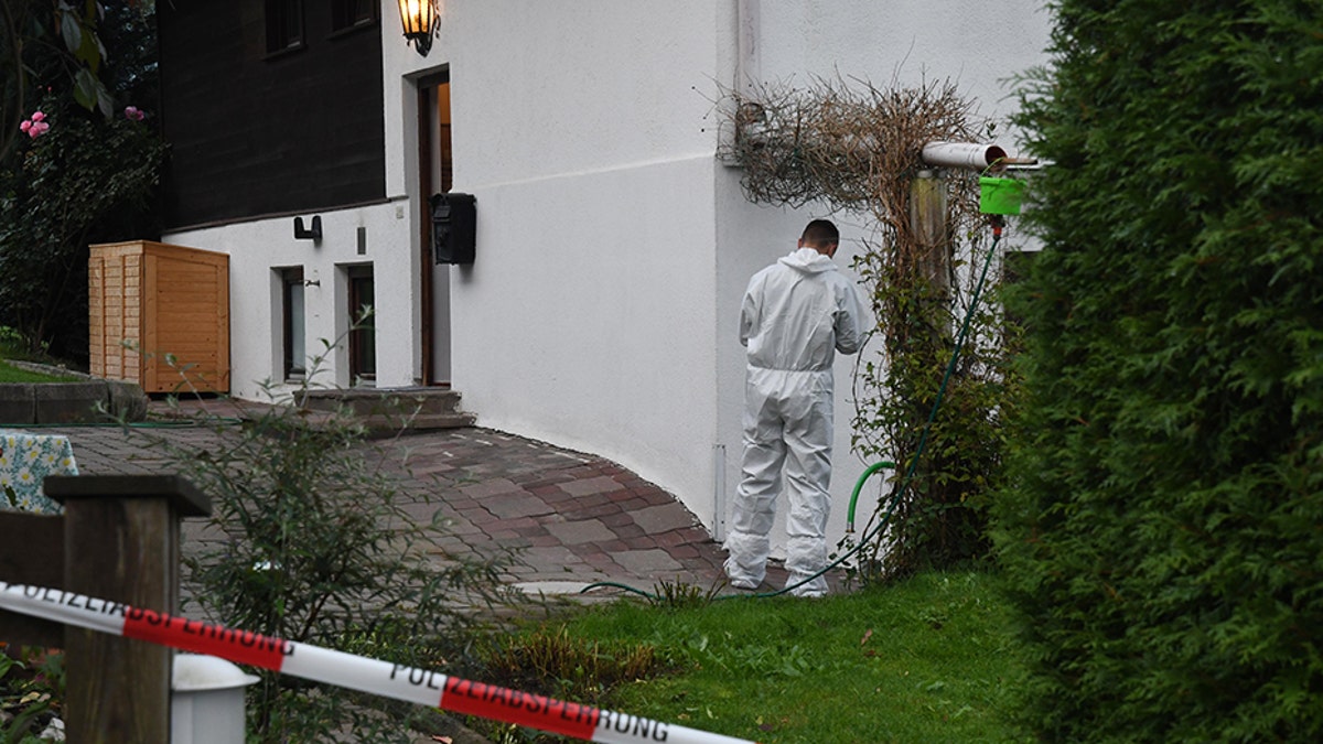 A forensic expert of the police secures the crime scene around a house in Kitzbuehel, Austria, where five people were killed on October 6, 2019.