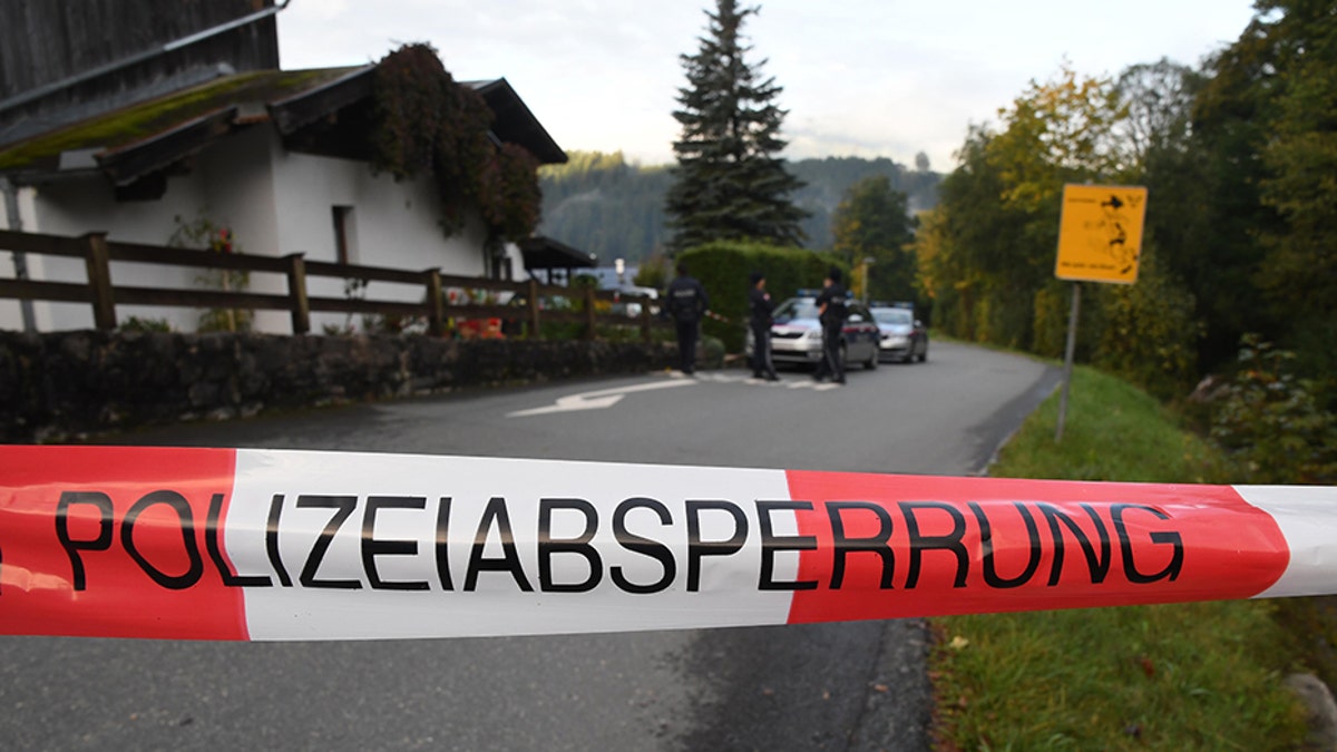 Policemen secure the crime scene around a house in Kitzbuehel, Austria, where five people were killed on October 6, 2019.