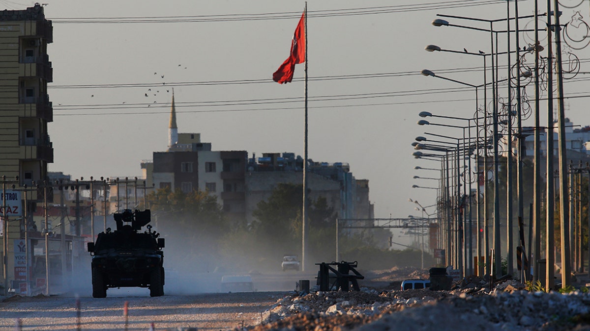 A Turkish police armored vehicle patrols the town of Akcakale, Sanliurfa province, southeastern Turkey, at the border with Syria, Saturday, Oct. 12, 2019. The towns along Turkey's border with northeastern Syria have been on high alert after dozens of mortars fired from Kurdish-held Syria landed, killing several civilians. (AP Photo/Lefteris Pitarakis)