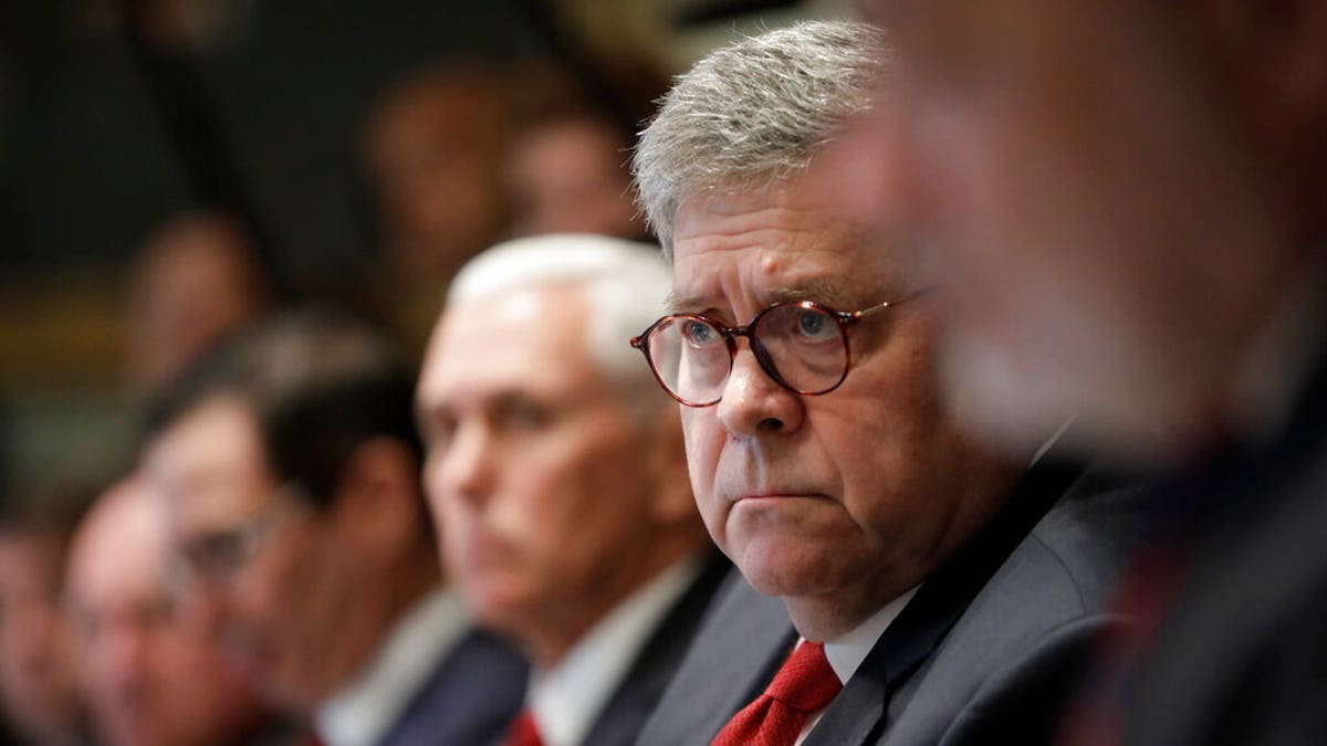 Attorney General William Barr, center, and Vice President Mike Pence, left of Barr, attend a Cabinet meeting in the Cabinet Room of the White House, Monday, Oct. 21, 2019, in Washington. (AP Photo/Pablo Martinez Monsivais)