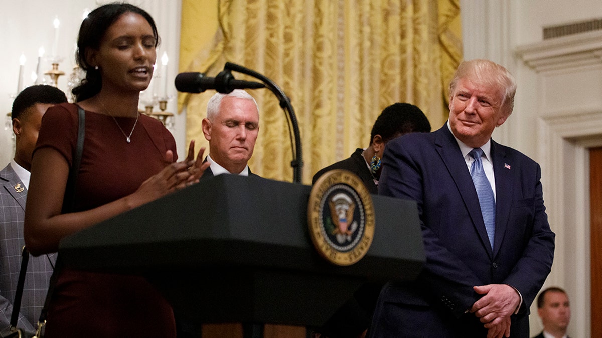 President Donald Trump and Vice President Mike Pence pause on stage during a prayer during the Young Black Leadership Summit at the White House in Washington, Friday, Oct. 4, 2019. (AP Photo/Carolyn Kaster)