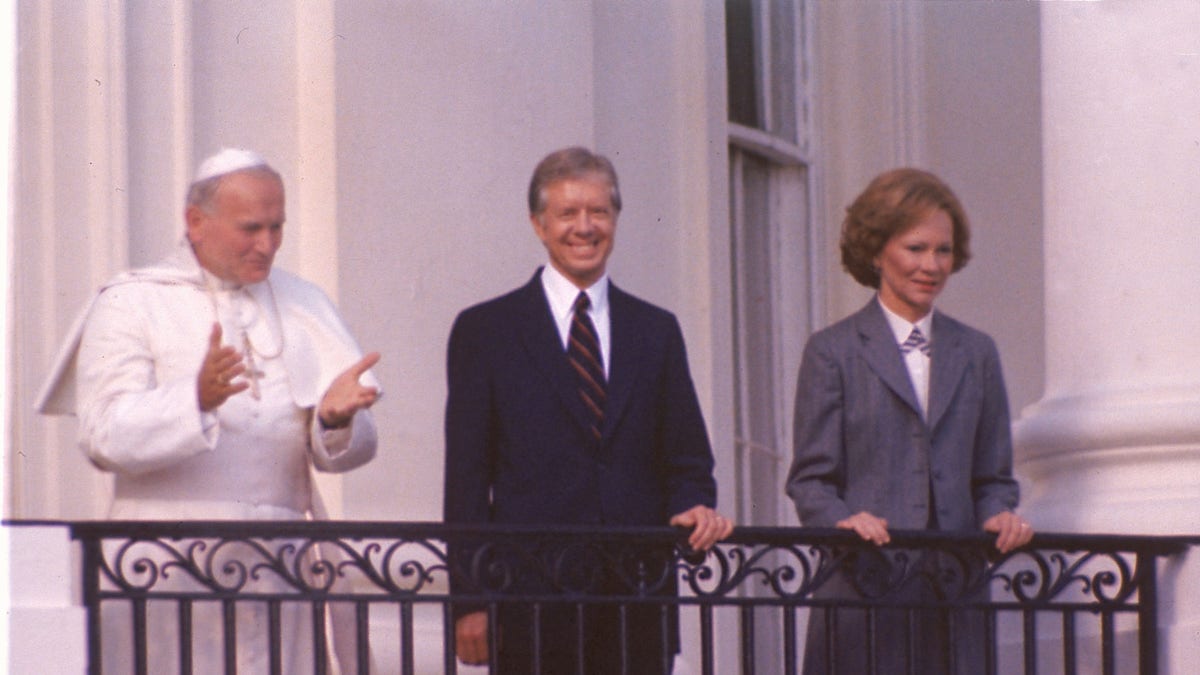 Pope John Paul II stands on the balcony of the White House with President Jimmy Carter and first lady Rosalynn Carter in Washington, D.C., on Oct. 6, 1979. (AP Photo)
