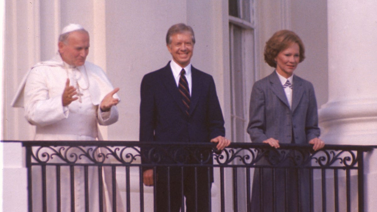 Pope John Paul II stands on the balcony of the White House with President Jimmy Carter and first lady Rosalynn Carter in Washington, D.C., on Oct. 6, 1979. (AP Photo)