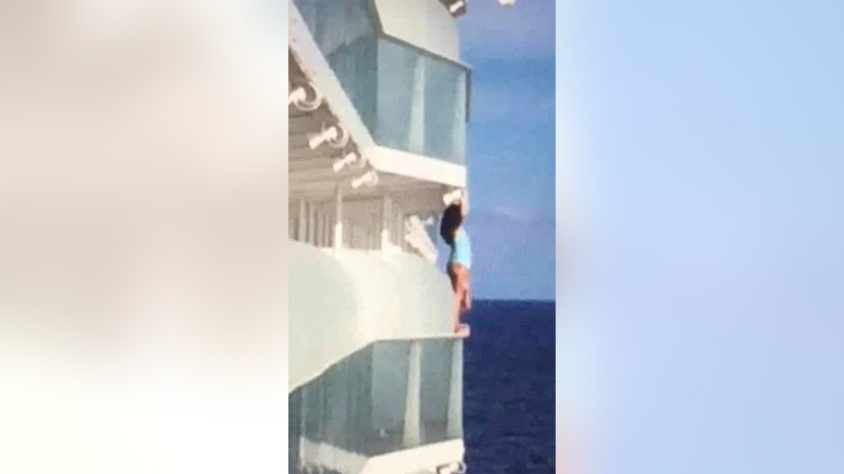 One Royal Caribbean cruise ship passenger, pictured, has been slammed as an “absolute idiot” for climbing over a balcony railing to take a swimsuit selfie, high above the ocean.