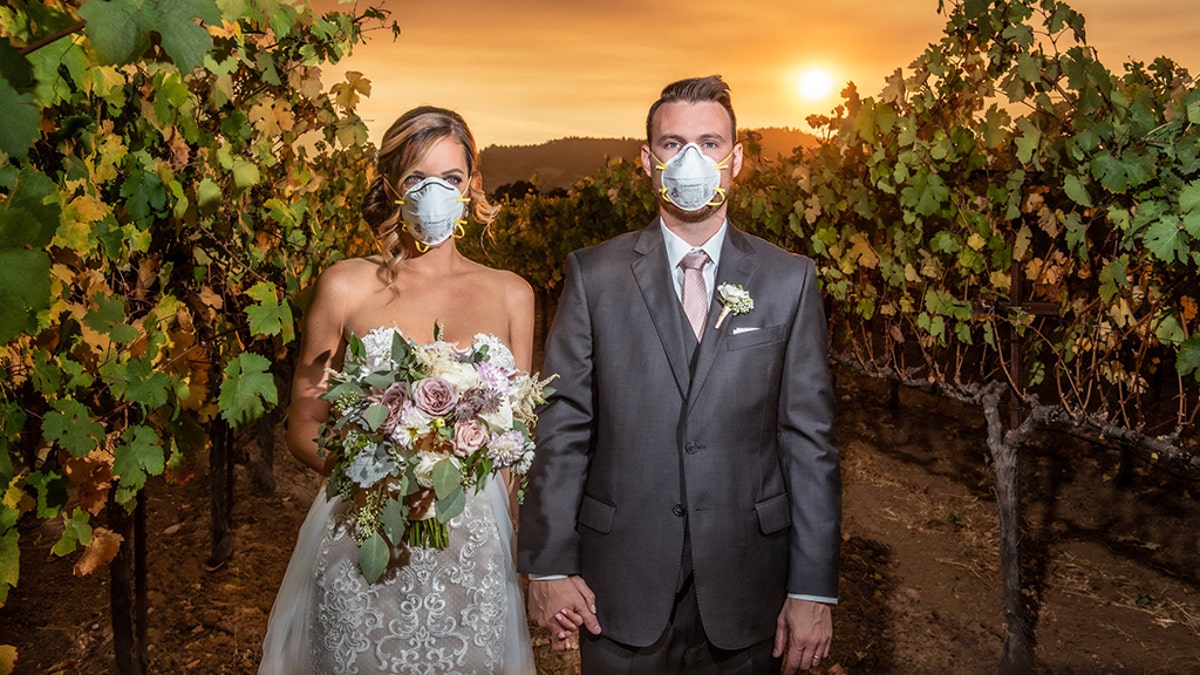 An Illinois couple got married in Northern California's famous Sonoma County on Saturday as a massive wildfire raged nearby, posing for a dramatic wedding photo as they wore masks, the photographer told Fox News.