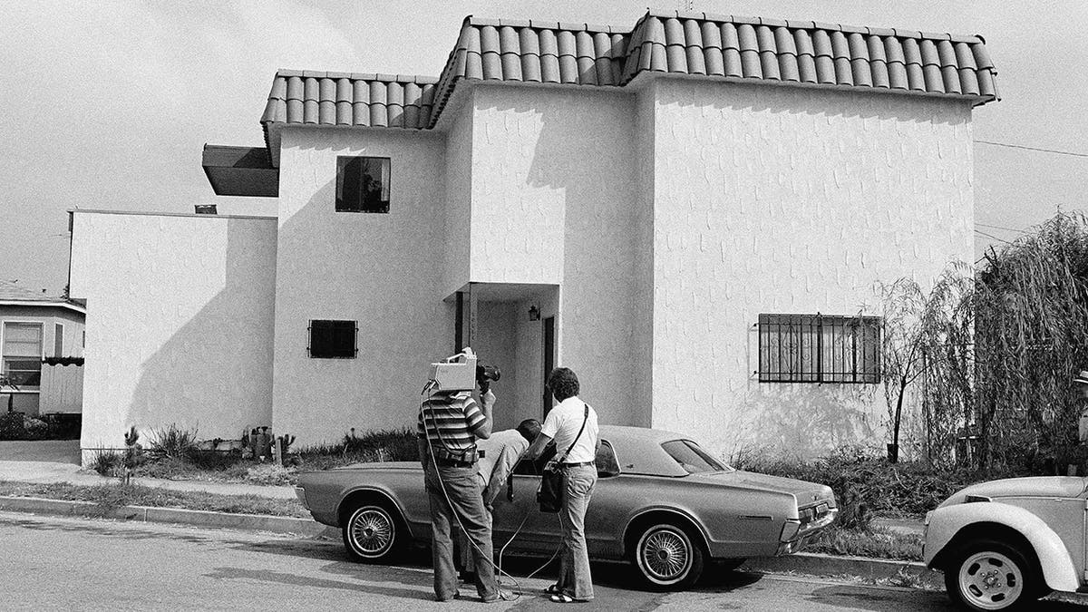 Newsmen examine the car of Dorothy Stratten, Playmate of the year 1980, after the nude bodies of her and her husband, Paul Snider, were found dead in this apartment in Los Angeles Aug. 14, 1980. Police said she was killed with a shotgun blast in the face, and Snider's body was on the floor on top of the gun.