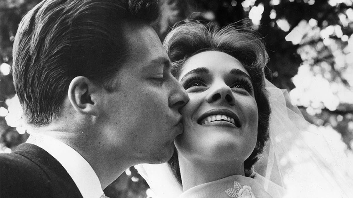 British costume designer Tony Walton kisses the cheek of his new bride, British actor and singer Julie Andrews. Their marriage lasted from 1959 until 1967.