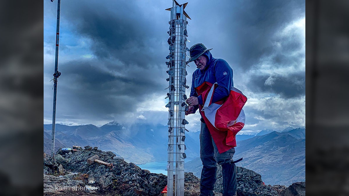 Gold Star Father Tom Wozencraft affixed the dog tags of his fallen heroes atop Gold Star Peak. (Keith Sherman)