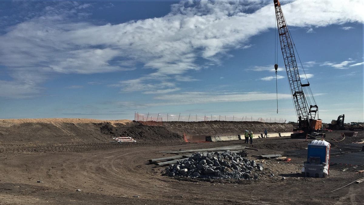 Workers lay the foundation for new wall near the Rio Grande Valley river, an area with many crossings, just southeast of McAllen, Texas. (Courtesy of CBP)