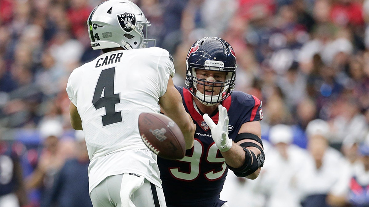 Houston Texans defensive end J.J. Watt (99) blocks a pass by Oakland Raiders quarterback Derek Carr (4) during the first half of an NFL football game Sunday, Oct. 27, 2019, in Houston. (AP Photo/Michael Wyke)